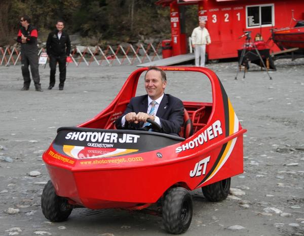 Prime Minister John Key gets behind the wheel of a Shotover Jet promotional vehicle